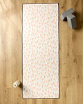 The Daisy Pop yoga mat by Hufton Studio is spread on a wooden floor with a slip-resistant towel. Two gray yoga blocks are at the top right, and a white water bottle is at the bottom left.