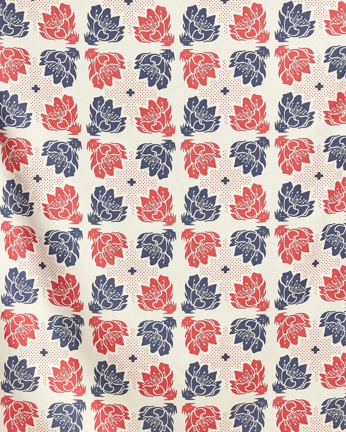 Founding Floral by Geometry features a grid of stylized blue and red flowers with dots and star shapes on cream—ideal for a quick-drying beach blanket made from recycled materials.