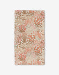 The Garden Bloom Luxe Bath Towel by Hufton Studio features a floral design in soft pink, peach, and beige on a light background and is crafted with ultra-absorbent Geoweave technology.