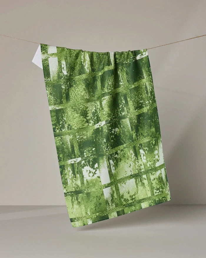 The Geometry Greenhouse tea towel hangs on a rope, offering ultra-absorbency—perfect for eco-friendly kitchens.
