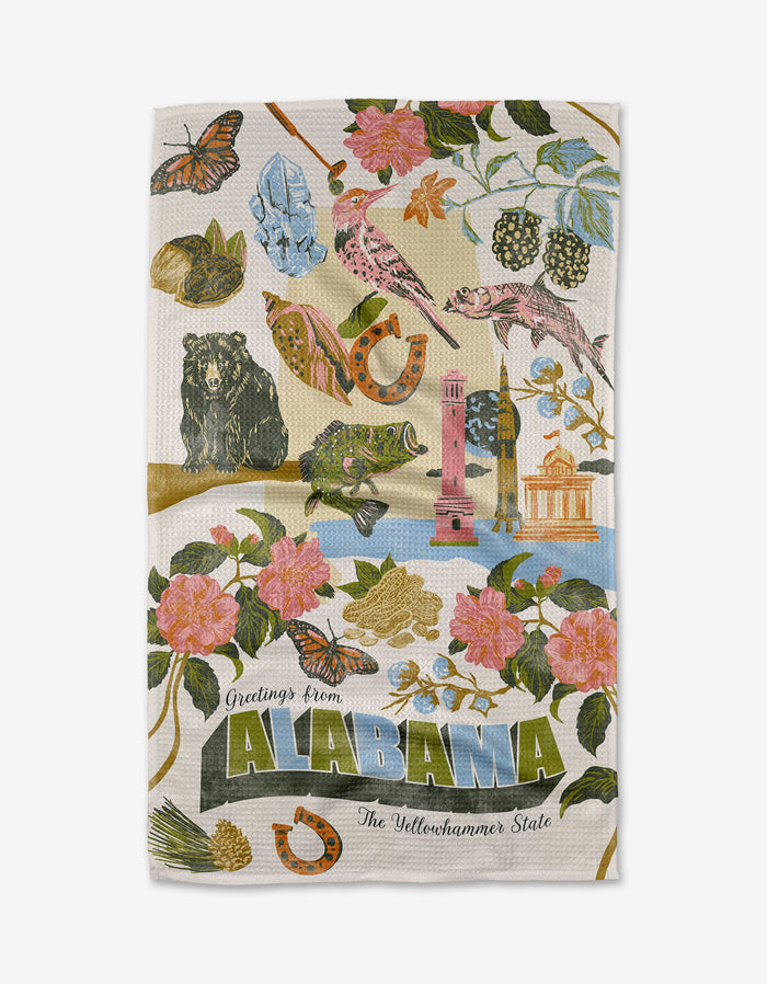 The Geometry "Greetings From Alabama" tea towel is ultra-absorbent, made from recycled materials, and features bright Alabama symbols—camellias, a bear, butterflies, peaches—with “Greetings from ALABAMA The Yellowhammer State.”.