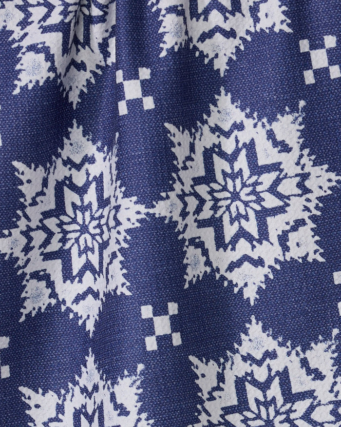 The Geometry Iceflower Blue kitchen towel features a blue fabric with a repeating white geometric snowflake pattern and small squares, a textured surface with slight folds, and is made from recycled materials—perfect for adding charm to your kitchen.