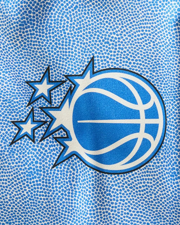 The Magic Grip by NBALAB x Geometry features a stylized blue basketball with three stars shooting from its left side, set against a textured background inspired by the surface of a quick-drying gym towel.