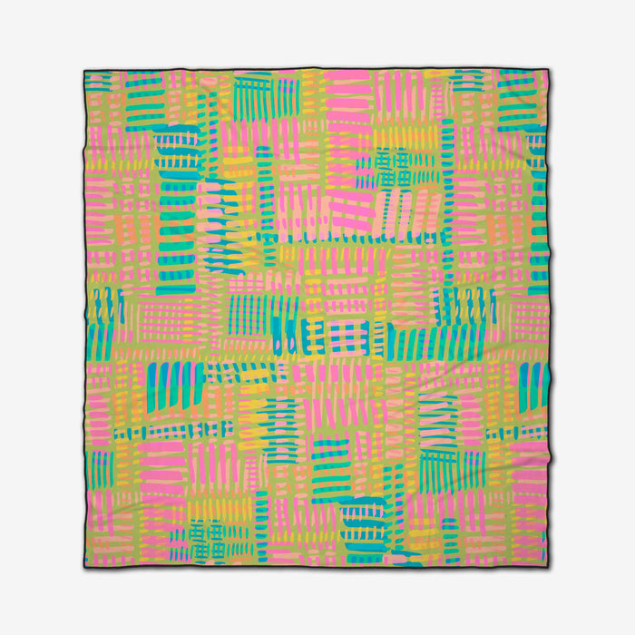 The Positive Vibes beach blanket by Sareka Unique is square, made from recycled materials, and features a colorful abstract brushstroke pattern in pink, yellow, blue, and green. Quick-drying for effortless beach days.