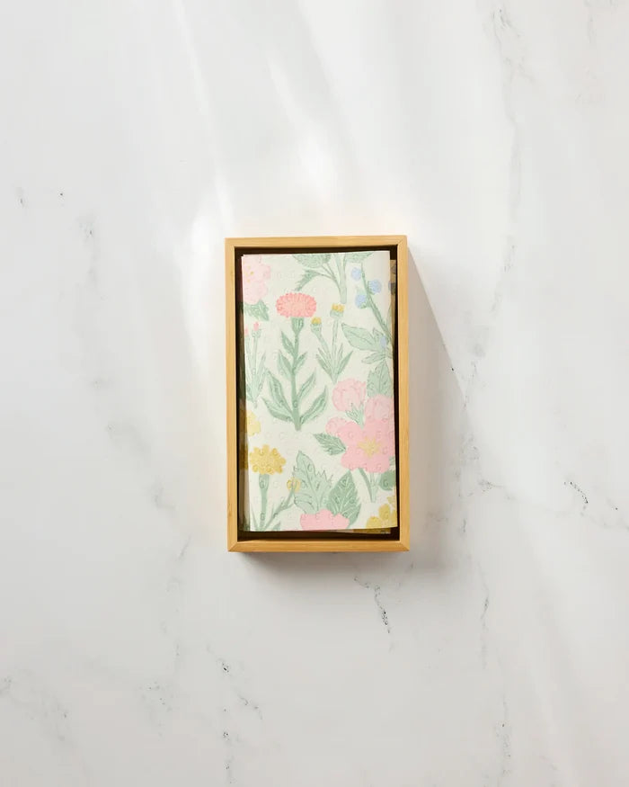 The "Wildflowers in Bloom" rectangular box by Jasmine Blooms Designs features a floral-patterned lid with pastel flowers and green leaves—ideal for storing eco-friendly paper towels on any white marble surface.