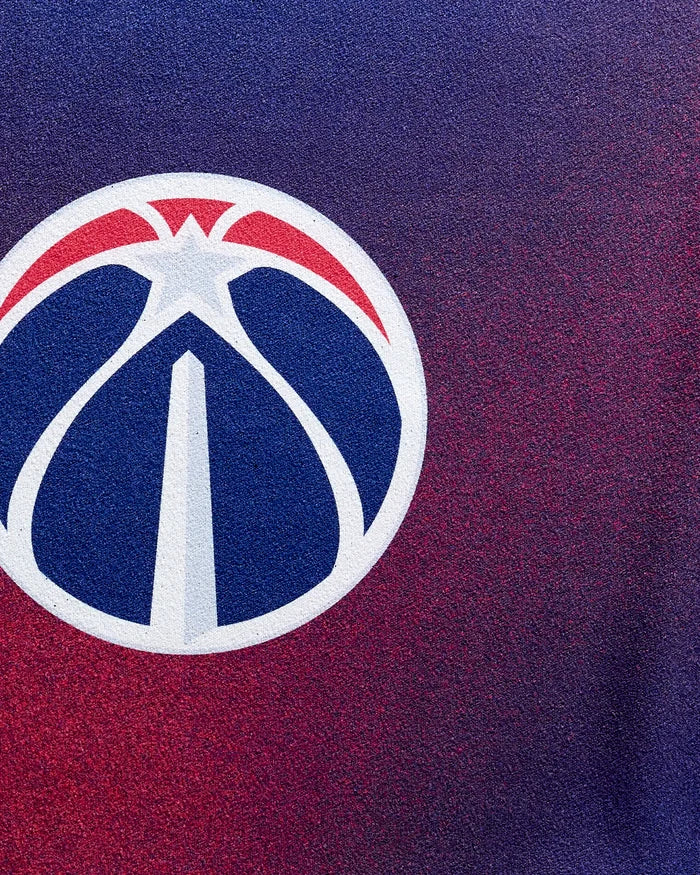 Show off the Wizards Fade towel by NBALAB x Geometry, featuring a close-up of the Washington Wizards logo with stylized blue and red on a purple-to-red fade—ideal as your NBA fitness or quick-drying gym towel.