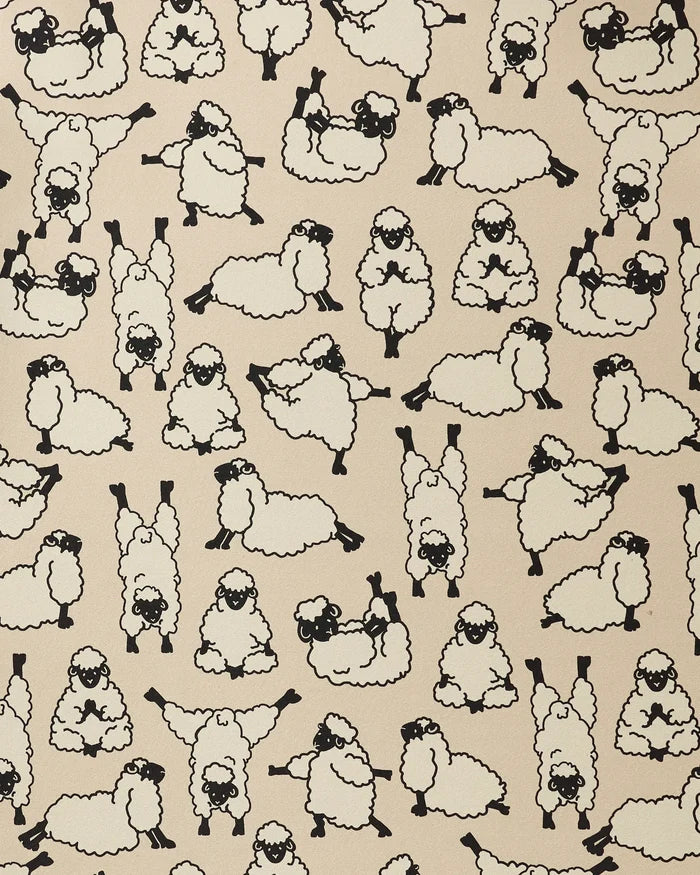 Yoga Sheep by Geometry features cartoon sheep in playful poses on a beige background. With simple black outlines and a lively, whimsical pattern, it's the perfect design for a recycled yoga towel.