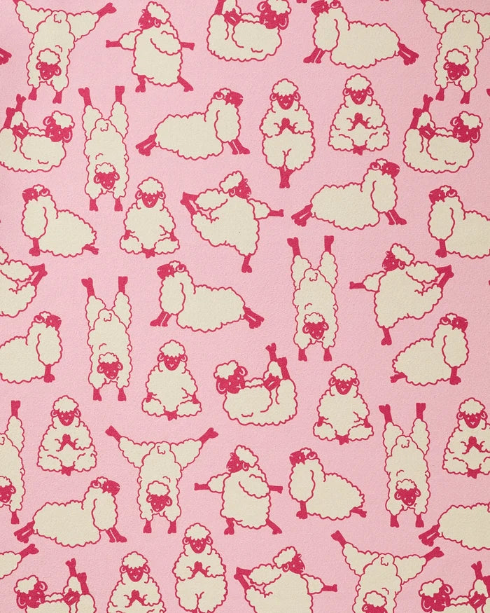 The Geometry Yoga Sheep towel features playful red-outlined cartoon sheep in yoga poses on a pink background, creating a fun and functional recycled yoga accessory.