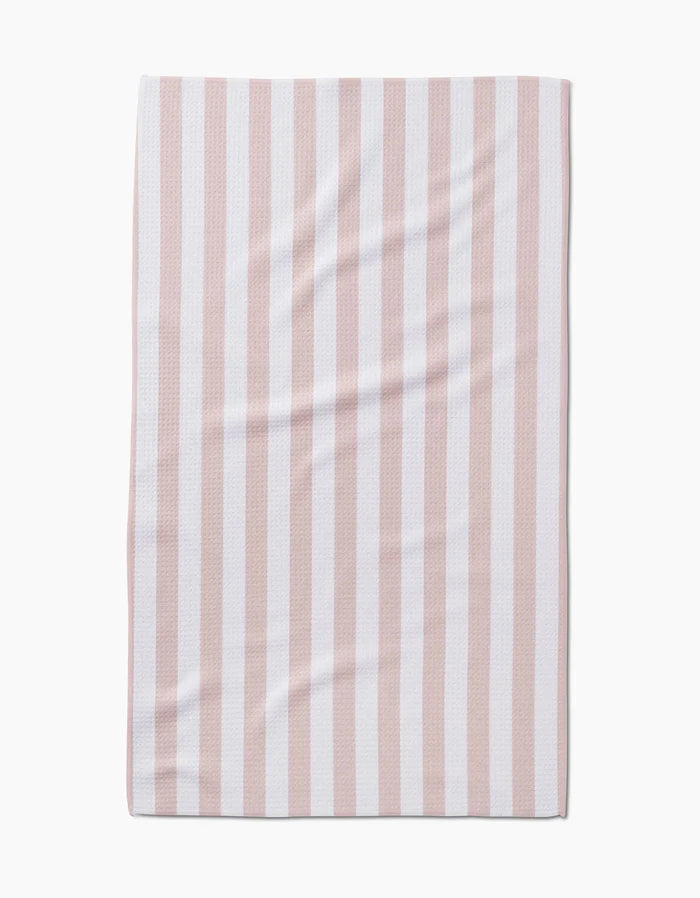 The Kailee Wright Yvonne Stripe Tea Towel features vertical pastel pink and white stripes, is made from Geoweave™ fabric for superior absorbency, and displays a smooth rectangular shape with subtle surface creases.